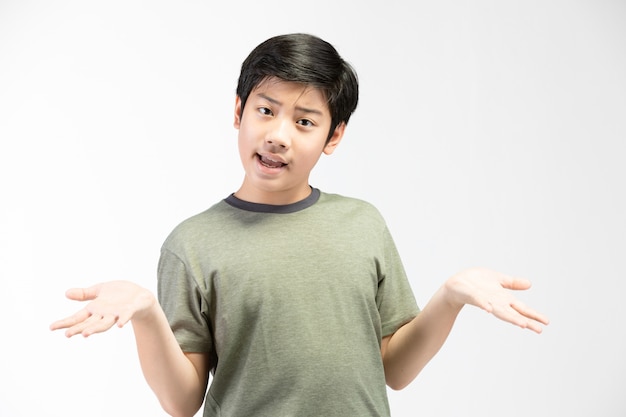 Little asian  boy with black hair in funny acting trying to amusing . 