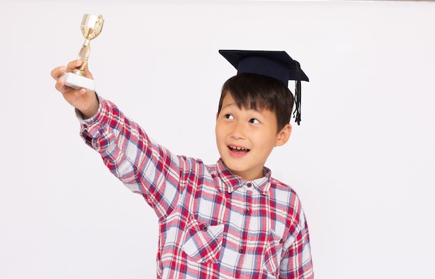 Little Asian boy with a cup trophy student winner boy