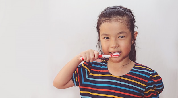 Little asian cute girl brush teeth