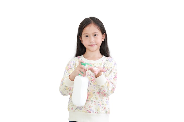 Little asian girl applying baby lotion in hands