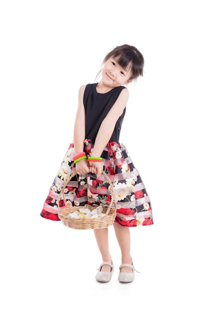 Little asian girl holding flower basket and smiling over white background