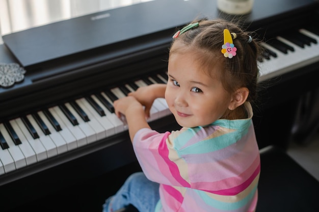 Little asian girl is happy playing the piano