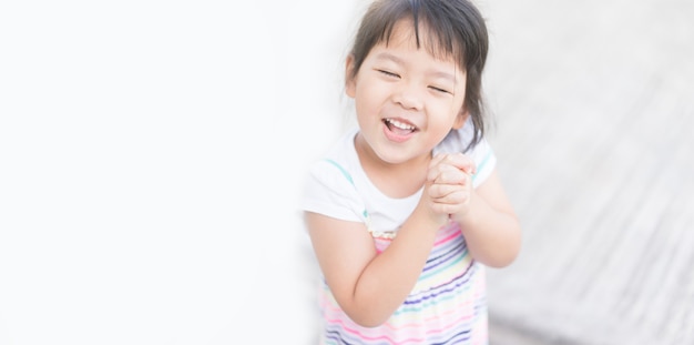 Little asian girl praying in the morning.