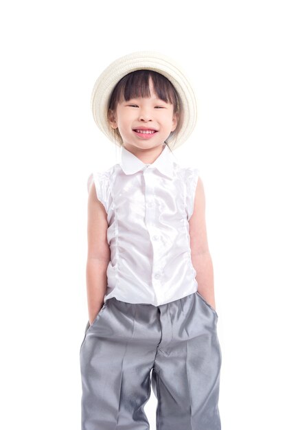 Little asian girl wearing hat and smiles over white background