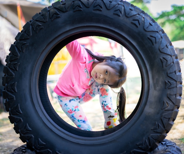 Little asian girl in the wheel outdoor