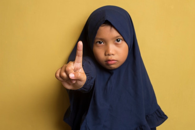 Little asian muslim hijab girl show one finger