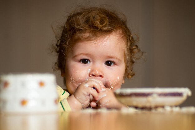 Little baby are eating little child eating fruit puree