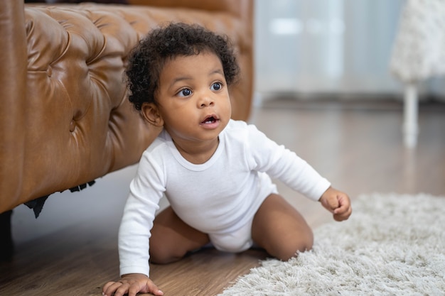 Little baby boy crawling and looking for something to learn