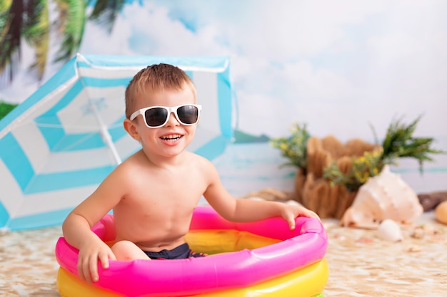 Little baby boy in an inflatable pool