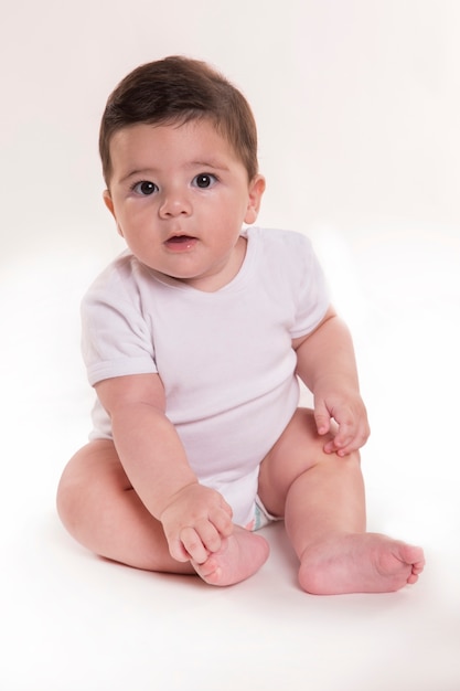 Little baby boy sitting and looking at camera. Brazilian baby.