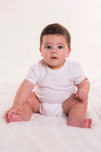 Little baby boy sitting and looking at camera. Brazilian baby.