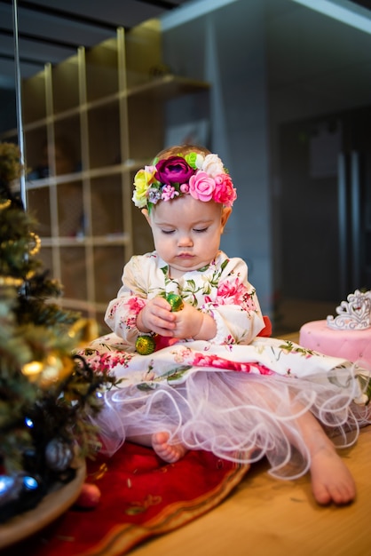 Piccola neonata vicino all'albero di natale