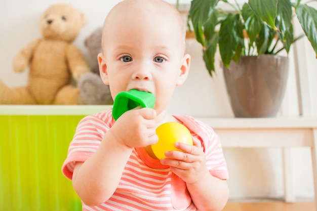 Little baby girl playing with educational toys