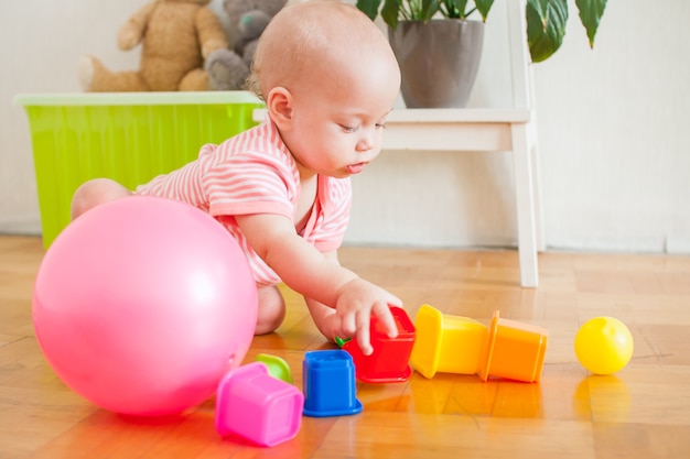 Little baby girl playing with educational toys