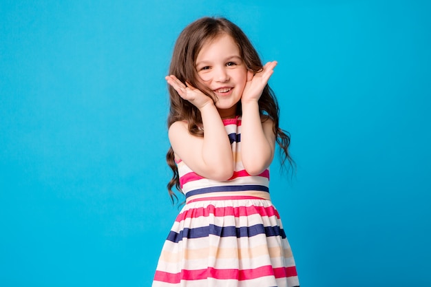 little baby girl smiling on blue 