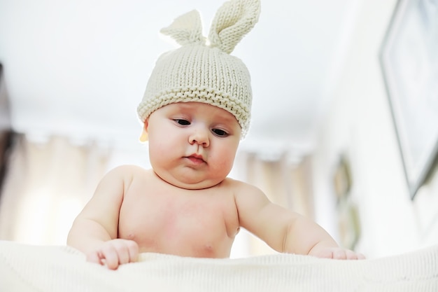 The little baby is lying on the crib. Newborn baby.