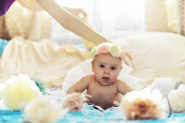 Photo the little baby is lying on the crib newborn