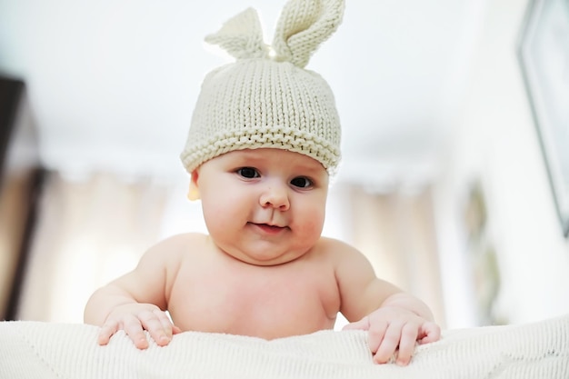 Photo the little baby is lying on the crib newborn