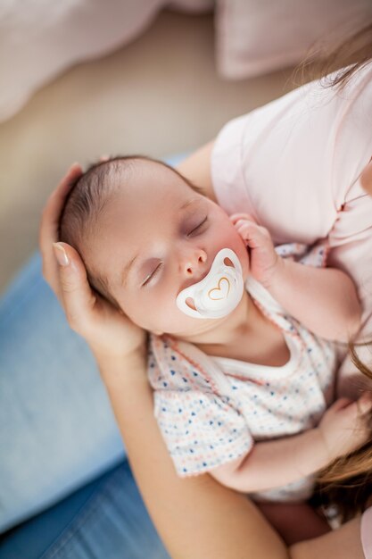 Little baby in mother's hands. Motherhood.