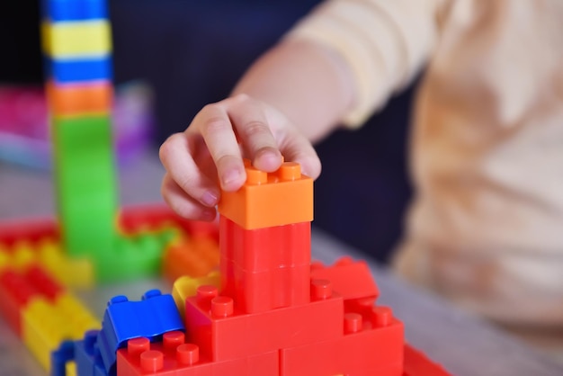 Little baby playing on table with colroful toys