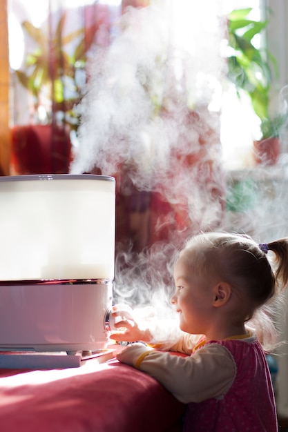 Little baby playing with humidifier