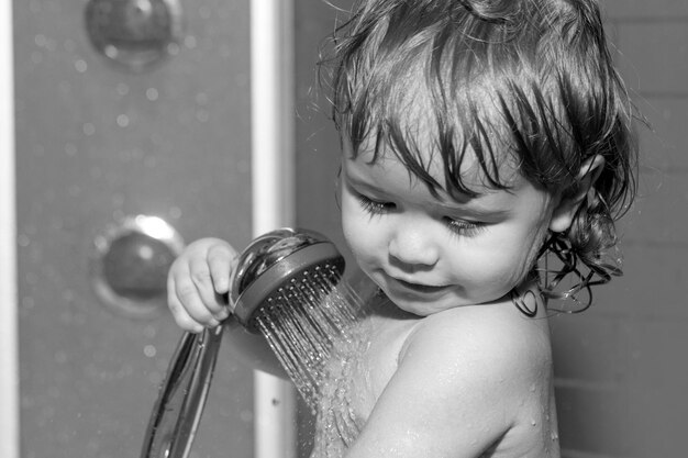 Little baby taking bath closeup face portrait of smiling boy health care and kids hygiene child bath