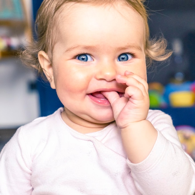 Little baby with blue eyes smiling baby portrait