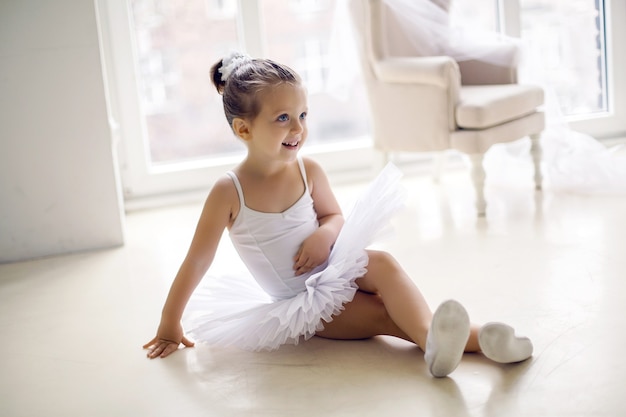 Little ballerina girl 2 years in a white tutu dress clothes