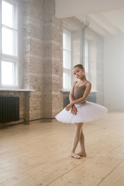 Little ballerina practicing ballet in dance school she preparing for the performance