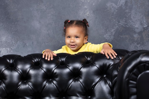 Little beautiful African American girl playing hide and seek