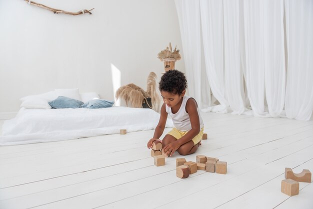 Little beautiful boy playing with wooden toys