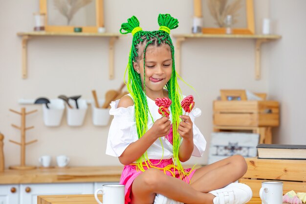 Little beautiful child girl in the kitchen at home happy and funny