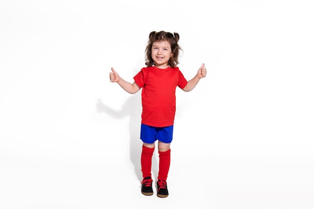 Little beautiful girl 5 years in football uniform isolated