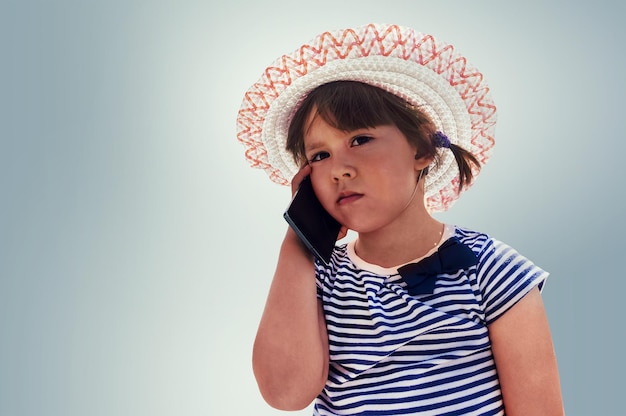 Little beautiful girl talking on the smartphone