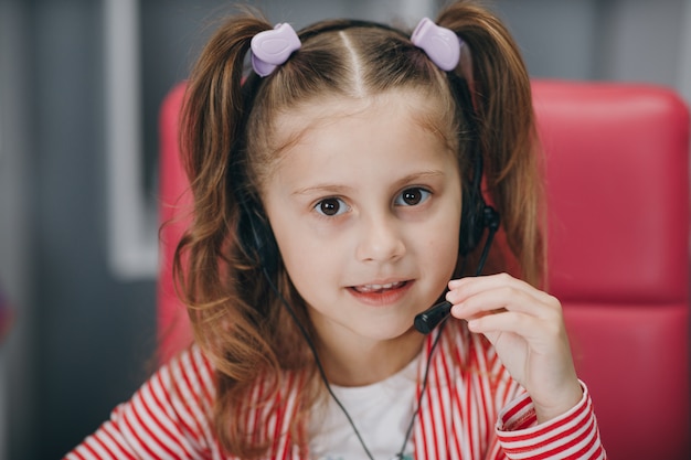 Little beautiful girl using a microphone