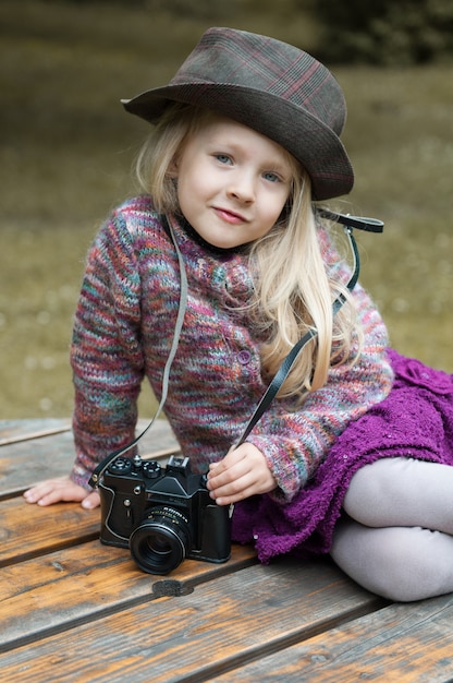 Little beautiful girl with a photo camera