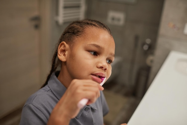 Little Biracial Girl Brushing Teeth