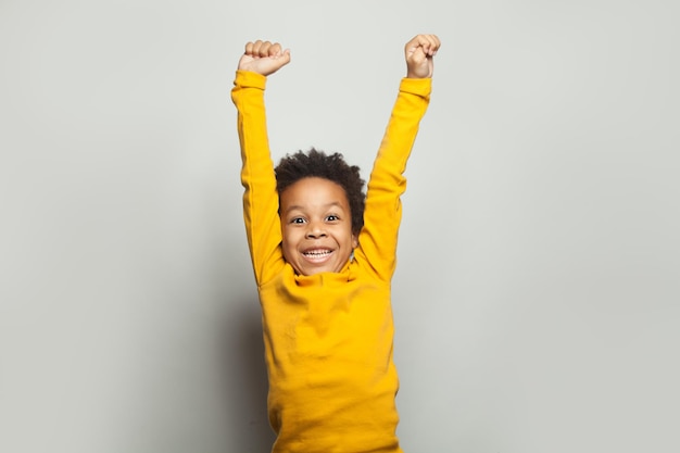 Little black child winwin Kid boy having fun on white background