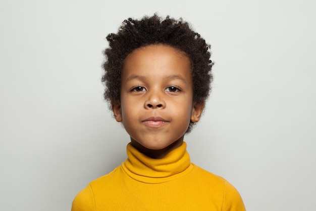 Little black kid face Cute child boy smiling on white background