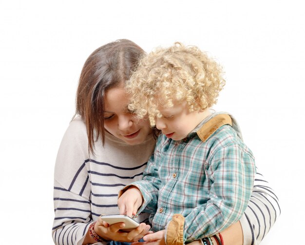  little blond boy playing with his sister's phone