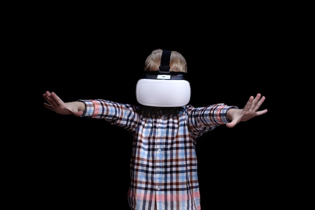 Little blond boy with glasses of virtual reality. Plaid shirt.