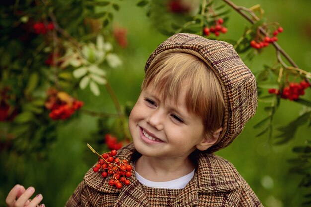 Little blond girl outdoors with berries