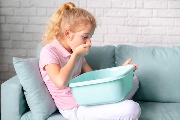 Little blonde girl feeling sick Suffering of nausea vomiting Food poisoning concept