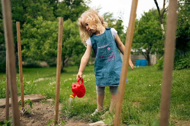 Little blonde girl gardening