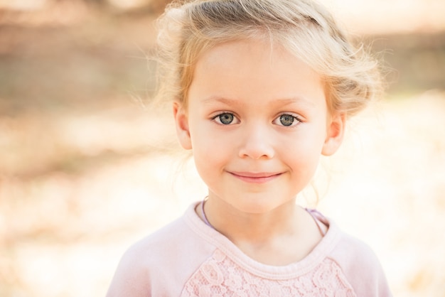 Little blonde girl posing outdoor