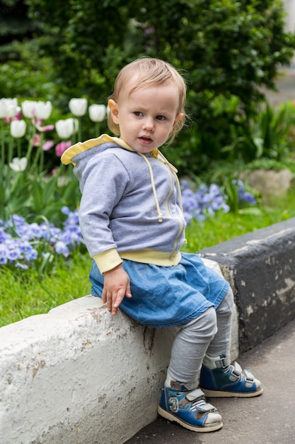 Little blonde girl sitting down