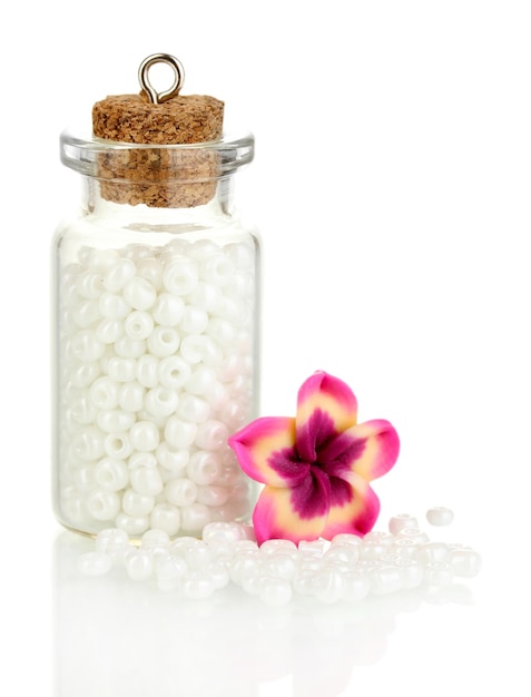 Little bottle full with colorful beads isolated on white