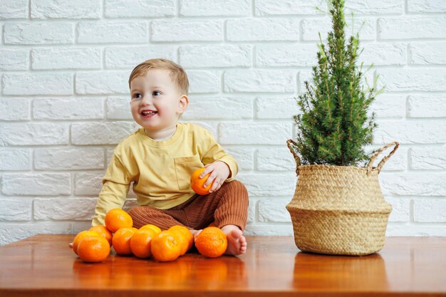 Little boy 2 years old eats tangerines The kid wants to sit on citrus fruits for the first time Healthy fruits for children