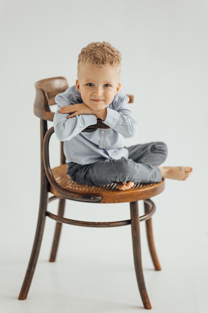 Little boy 4 years old blond in a shirt