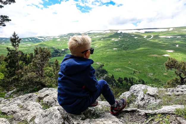 A little boy on the background of the LagoNaki plateau in Adygea Russia